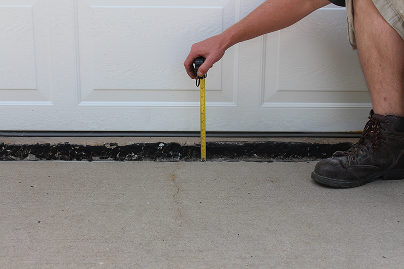 Garage door concrete lifting project - before